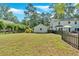 Expansive backyard with lush green lawn, featuring a detached garage and a privacy fence, offering seclusion at 1406 Arden Sw Dr, Marietta, GA 30008