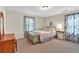 Cozy bedroom with neutral carpet, plenty of natural light, and a vintage dresser at 1406 Arden Sw Dr, Marietta, GA 30008