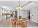 Bright dining room connected to the kitchen featuring a wooden table and backyard view at 1406 Arden Sw Dr, Marietta, GA 30008