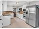 Modern kitchen with stainless steel appliances, white cabinetry, and tile backsplash at 1406 Arden Sw Dr, Marietta, GA 30008