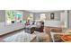 Relaxing living room featuring hardwood floors, wainscoting, and an outdoor view at 1406 Arden Sw Dr, Marietta, GA 30008
