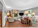 Inviting living room with hardwood floors, brick fireplace, and comfortable seating at 1406 Arden Sw Dr, Marietta, GA 30008