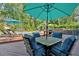 Outdoor patio featuring comfortable seating and shade umbrellas with a pool and lush landscaping at 1406 Arden Sw Dr, Marietta, GA 30008