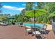 Inviting pool area with lounge chairs, dining set, and lush landscaping offers a perfect outdoor retreat at 1406 Arden Sw Dr, Marietta, GA 30008