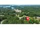 Aerial view of the neighborhood surrounded by lush greenery and Lake Norman in the distance at 2015 Buford Dam Rd, Buford, GA 30518