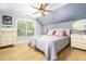 Comfortable bedroom features neutral tones, a ceiling fan, and lots of natural light at 2015 Buford Dam Rd, Buford, GA 30518