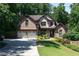 Charming two-story brick home featuring a well-manicured lawn and a two-car garage at 2015 Buford Dam Rd, Buford, GA 30518