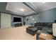 Finished basement living room with a TV, sofa, ottoman, and carpeted floors at 2015 Buford Dam Rd, Buford, GA 30518