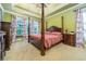 Spacious main bedroom featuring a four-poster bed, tray ceilings and large windows with natural light at 2015 Buford Dam Rd, Buford, GA 30518