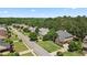 Aerial view showcasing a home with an attached garage and beautifully landscaped lawn in a serene setting at 2660 Brentwood Estates Ct, Cumming, GA 30041