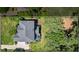 An aerial view of a home with a gray roof, green trees, and lush backyard at 2660 Brentwood Estates Ct, Cumming, GA 30041