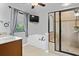 Bathroom featuring a glass enclosed shower, tub, and sink at 2660 Brentwood Estates Ct, Cumming, GA 30041