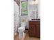 Cozy bathroom with wood vanity and shower with stylish curtain at 2660 Brentwood Estates Ct, Cumming, GA 30041