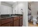 Bathroom features a dark granite countertop vanity, stylish faucet and towel rack, and tiled floors at 2660 Brentwood Estates Ct, Cumming, GA 30041