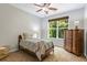Cozy bedroom with a twin bed, dresser, and a bright window at 2660 Brentwood Estates Ct, Cumming, GA 30041