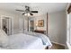 Bedroom features a four poster bed, ceiling fan, two closets, and natural light streaming in from a window at 2660 Brentwood Estates Ct, Cumming, GA 30041
