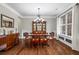 Elegant dining room with hardwood floors, wainscoting, chandelier, and large windows at 2660 Brentwood Estates Ct, Cumming, GA 30041