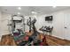 Spacious home gym with workout equipment, sleek lighting, and stylish wooden floors at 2660 Brentwood Estates Ct, Cumming, GA 30041