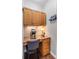 A cozy nook with wooden cabinets, granite countertops, and under-cabinet lighting, ideal for a home office setup at 2660 Brentwood Estates Ct, Cumming, GA 30041