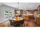 Eat-in kitchen with hardwood floors, custom cabinets, and stainless appliances at 2660 Brentwood Estates Ct, Cumming, GA 30041
