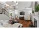 Open-concept living room with hardwood floors, staircase, and vaulted ceilings at 2660 Brentwood Estates Ct, Cumming, GA 30041