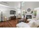 Spacious living room with fireplace, hardwood floors and natural light at 2660 Brentwood Estates Ct, Cumming, GA 30041