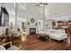 Bright living room with a fireplace, hardwood floors, and a soaring ceiling at 2660 Brentwood Estates Ct, Cumming, GA 30041