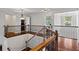 An open loft area featuring wooden railings and hardwood floors, creating a bright and inviting space at 2660 Brentwood Estates Ct, Cumming, GA 30041