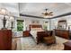 A spacious main bedroom showcasing a tray ceiling, hardwood floors, and ample natural light at 2660 Brentwood Estates Ct, Cumming, GA 30041