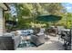 Outdoor patio with comfortable seating and an umbrella at 2660 Brentwood Estates Ct, Cumming, GA 30041