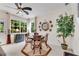 Bright dining room with seating for four, natural light, decorative clock, and indoor tree at 3733 Chattahoochee Summit Se Dr # 7, Atlanta, GA 30339