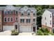 Stunning brick townhome featuring a two-car garage, neat walkway, and manicured garden at 3733 Chattahoochee Summit Se Dr # 7, Atlanta, GA 30339