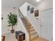 Inviting staircase with carpeted steps, wooden banister, decorative iron spindles, and neutral wall decor at 3733 Chattahoochee Summit Se Dr # 7, Atlanta, GA 30339
