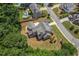 Aerial view showcasing the backyard, screened porch, and surrounding landscape of a well-manicured home at 501 Highwater Pass, Canton, GA 30114