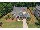 An aerial shot of a home's manicured lawn, landscaping, and driveway, highlighting its curb appeal at 501 Highwater Pass, Canton, GA 30114