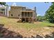 An expansive backyard with a screened porch, lush green lawn, and mature trees, offering a private outdoor space at 501 Highwater Pass, Canton, GA 30114