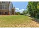 A well-maintained backyard with mature trees, offering privacy and a peaceful outdoor setting at 501 Highwater Pass, Canton, GA 30114