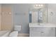 Bathroom featuring a vanity, mirror, toilet, shower/bath, and a window for natural light at 501 Highwater Pass, Canton, GA 30114