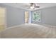 Spacious bedroom featuring neutral walls and carpet, and a view into the attached bathroom at 501 Highwater Pass, Canton, GA 30114