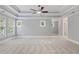 Spacious bedroom featuring neutral walls, carpet, tray ceilings and an abundance of natural light at 501 Highwater Pass, Canton, GA 30114