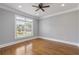 Spacious bedroom with beautiful hardwood floors, a large window, and neutral paint at 501 Highwater Pass, Canton, GA 30114