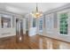 A spacious dining area with hardwood flooring, stylish wainscoting, and an open layout to other living spaces at 501 Highwater Pass, Canton, GA 30114