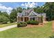 Well maintained brick home with lush lawn, mature trees, and driveway, and a basketball hoop at 501 Highwater Pass, Canton, GA 30114