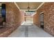 A side view of a brick house featuring a covered area, garage, and a dark door at 501 Highwater Pass, Canton, GA 30114