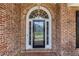 Elegant front door with decorative glass detailing, sidelights and brick surround at 501 Highwater Pass, Canton, GA 30114