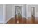 Long hallway featuring hardwood floors, neutral paint, and decorative trim at 501 Highwater Pass, Canton, GA 30114