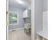 Functional laundry room with a utility sink, storage cabinets, and tiled flooring for easy maintenance at 501 Highwater Pass, Canton, GA 30114