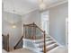 A well-lit stairway with decorative iron spindles and wood railing, leading to the upper level at 501 Highwater Pass, Canton, GA 30114
