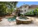 Private backyard oasis with a stone hot tub, in-ground pool, and lush greenery at 510 Northland Ridge Ct, Sandy Springs, GA 30342