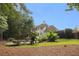Lush backyard with mature trees, landscaping, and a fire pit area, creating a private outdoor oasis at 510 Northland Ridge Ct, Sandy Springs, GA 30342